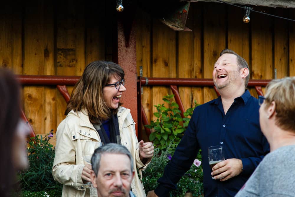 two people laughing at an event at park house barn