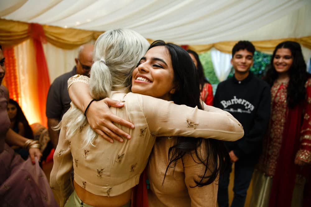 hug at a mehndi celebration