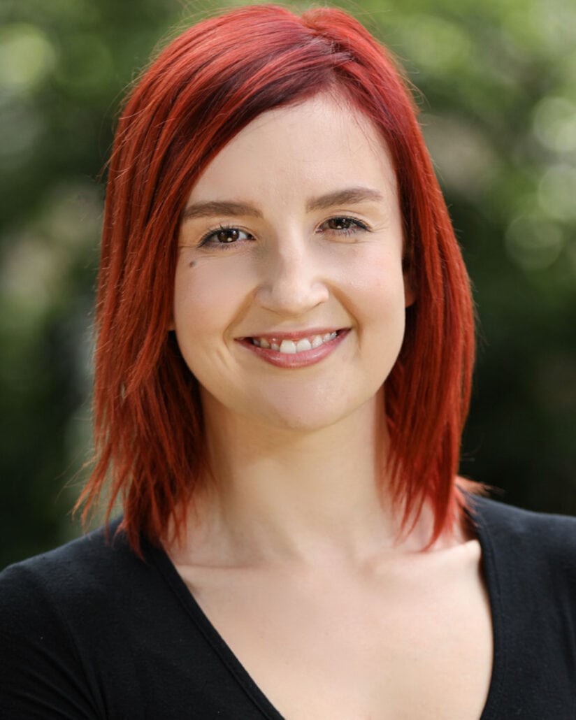 headshot of a red haired lady who needs a new business profile
